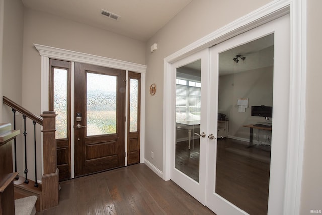 foyer featuring dark wood-style flooring, french doors, stairs, baseboards, and visible vents