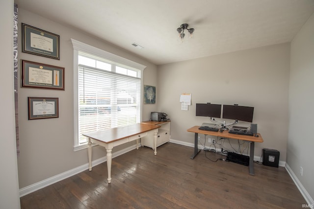 office featuring baseboards, wood finished floors, and a wealth of natural light