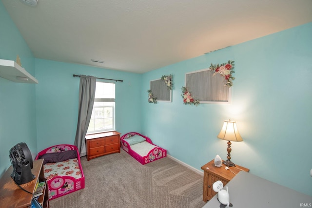 bedroom with carpet floors, baseboards, and visible vents
