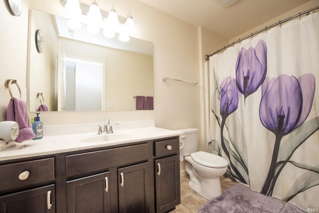 bathroom with vanity, tile patterned floors, toilet, and curtained shower