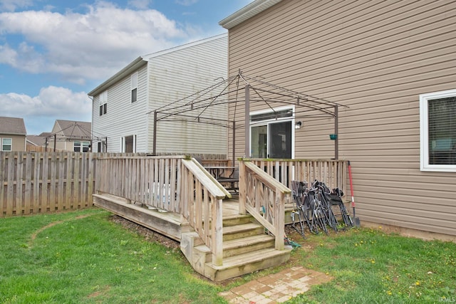 wooden terrace with a yard and a fenced backyard