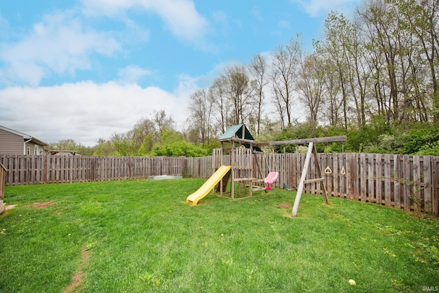 view of yard featuring a playground and a fenced backyard