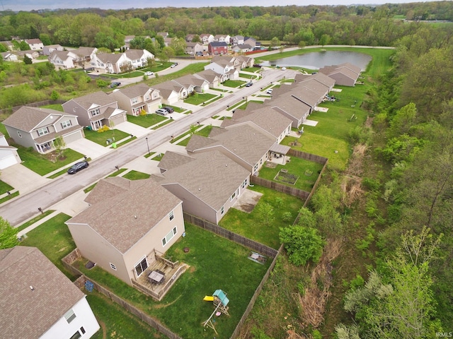 drone / aerial view with a water view and a residential view