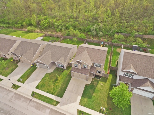 drone / aerial view with a residential view and a wooded view