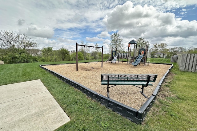 community playground featuring a lawn and fence