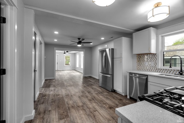 kitchen featuring a sink, stainless steel appliances, recessed lighting, decorative backsplash, and dark wood-style floors