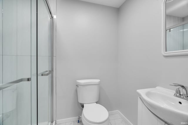 bathroom featuring toilet, baseboards, marble finish floor, and a stall shower