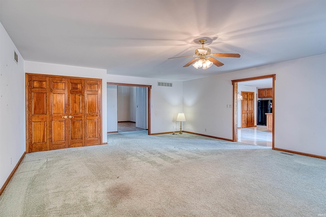 7001 Old Boonville Hwy, Evansville, IN 47715 - unfurnished bedroom with visible vents, freestanding refrigerator, baseboards, and light colored carpet