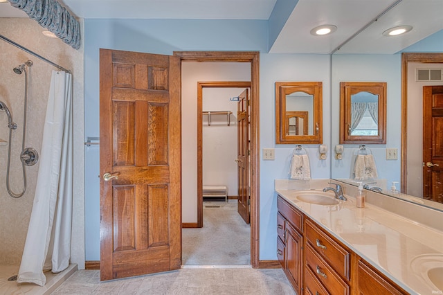 7001 Old Boonville Hwy, Evansville, IN 47715 - bathroom with double vanity, visible vents, a sink, baseboards, and a shower with shower curtain
