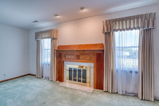 7001 Old Boonville Hwy, Evansville, IN 47715 - unfurnished living room featuring carpet flooring, visible vents, a fireplace with flush hearth, and a wealth of natural light