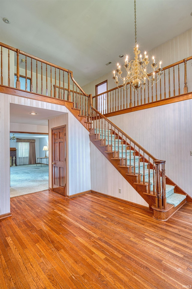 7001 Old Boonville Hwy, Evansville, IN 47715 - stairway with an inviting chandelier, hardwood / wood-style flooring, and visible vents