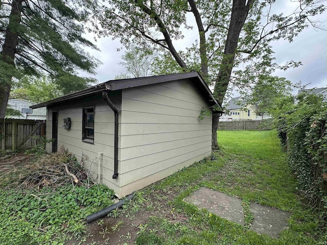 view of outbuilding featuring fence