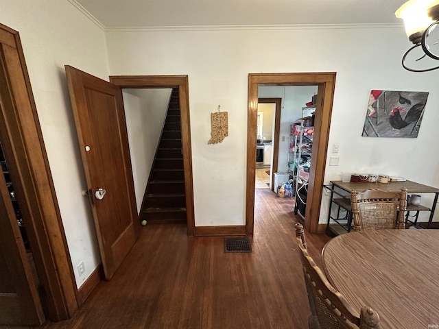 hall featuring crown molding, dark wood-style floors, stairway, and visible vents