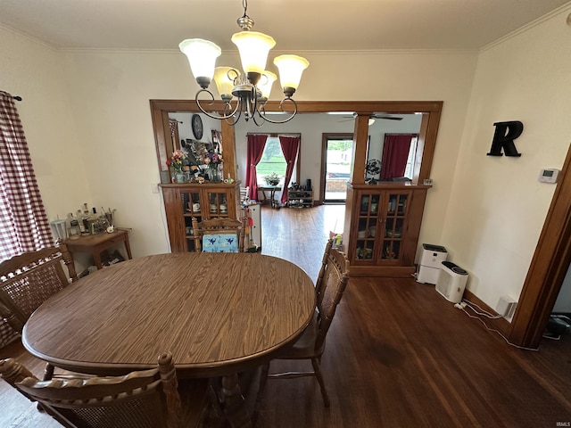 dining room featuring crown molding, baseboards, wood finished floors, and ceiling fan with notable chandelier