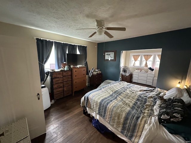 bedroom with ceiling fan, multiple windows, and hardwood / wood-style floors