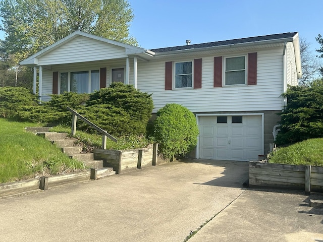 ranch-style house with an attached garage and concrete driveway