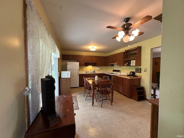 kitchen with open shelves, a sink, white appliances, a ceiling fan, and light floors