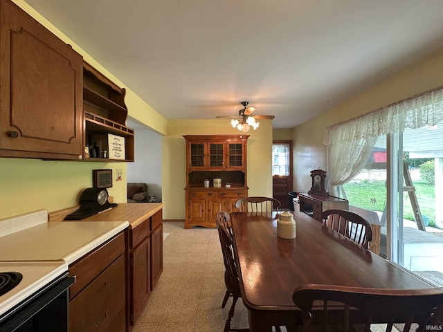 dining area with a ceiling fan and light floors