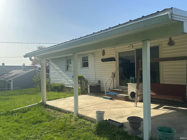 back of property featuring a lawn, a patio area, central air condition unit, and entry steps