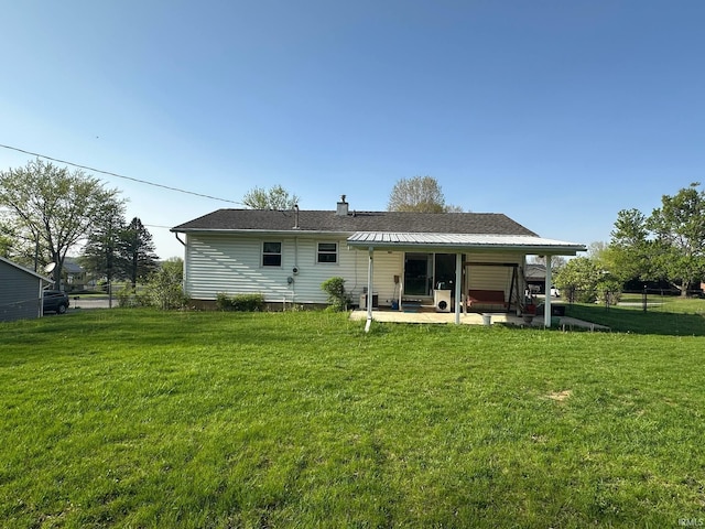 back of house with a lawn, a chimney, and a patio area