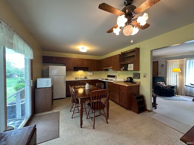 kitchen with a ceiling fan, open shelves, a sink, light countertops, and white appliances