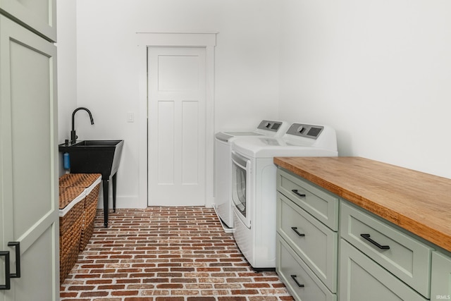 1284 E Zinnia Dr, Bloomington, IN 47401 - clothes washing area with separate washer and dryer, brick floor, and cabinet space