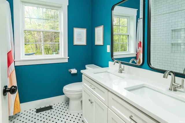 1284 E Zinnia Dr, Bloomington, IN 47401 - bathroom with a sink, baseboards, toilet, and visible vents
