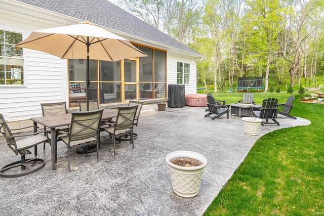 1284 E Zinnia Dr, Bloomington, IN 47401 - view of patio / terrace with a trampoline and outdoor dining space