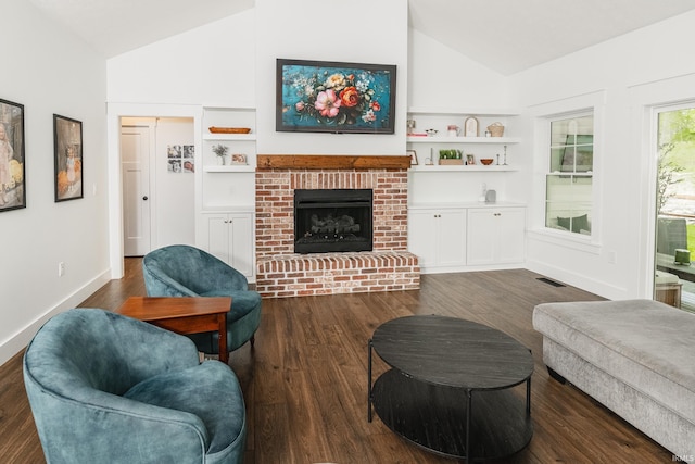 1284 E Zinnia Dr, Bloomington, IN 47401 - living area with dark wood finished floors, a brick fireplace, and high vaulted ceiling