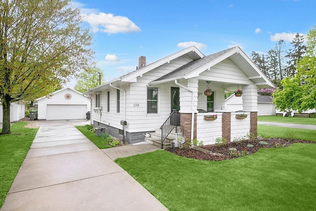 view of front of property with a porch, a chimney, a detached garage, an outdoor structure, and a front lawn
