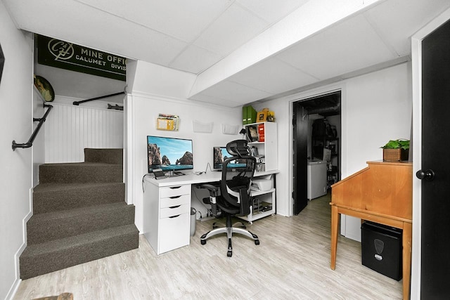 office area featuring a drop ceiling and light wood-type flooring