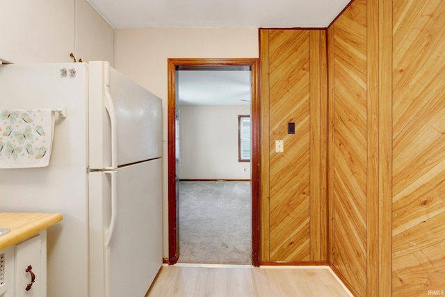 kitchen with freestanding refrigerator and wood finished floors