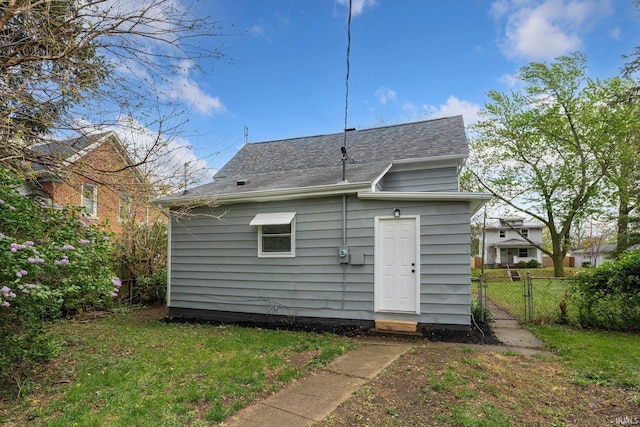 1743 Franklin Ave, Fort Wayne, IN 46808 - back of house featuring a lawn, a gate, roof with shingles, and fence