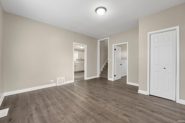 1743 Franklin Ave, Fort Wayne, IN 46808 - unfurnished bedroom featuring visible vents, baseboards, dark wood-style floors, and a closet