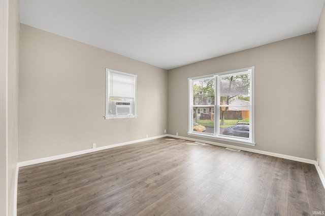1743 Franklin Ave, Fort Wayne, IN 46808 - empty room with baseboards, cooling unit, wood finished floors, and visible vents