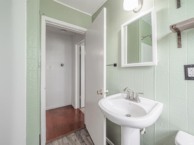 bathroom with a sink, toilet, and wood finished floors