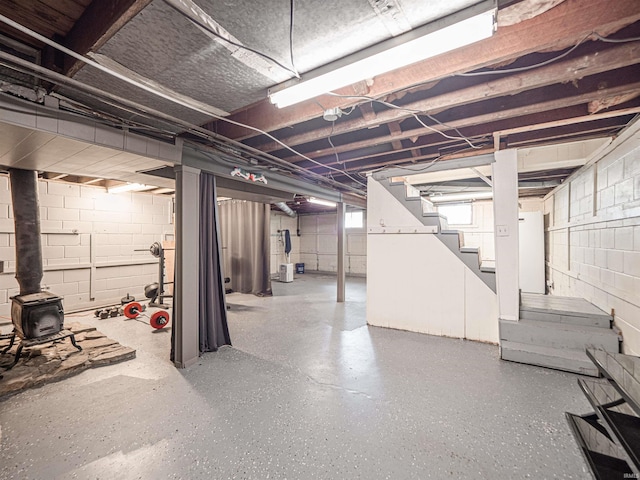 below grade area with a wood stove and stairs