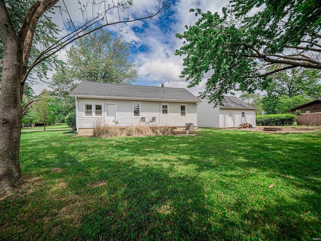 back of house featuring a lawn