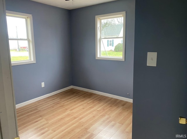 unfurnished room featuring baseboards, light wood-style flooring, and ceiling fan
