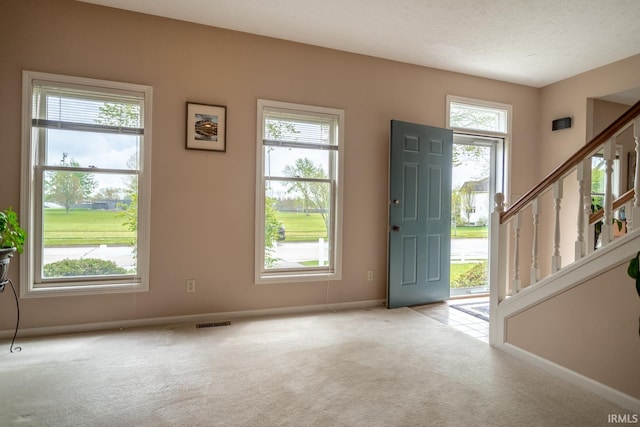 534 Lagrange St, West Lafayette, IN 47906 - foyer with stairway, baseboards, carpet flooring, and visible vents