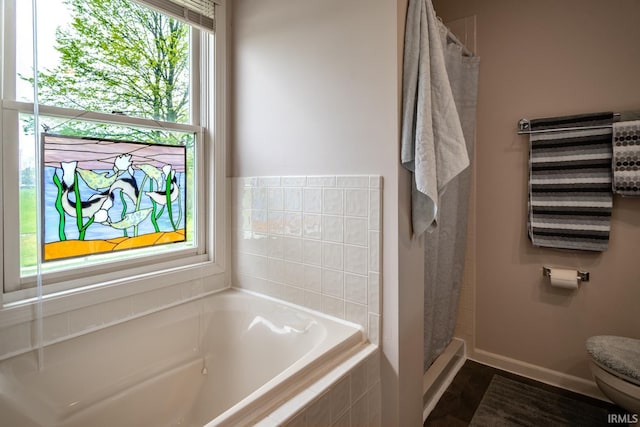 534 Lagrange St, West Lafayette, IN 47906 - full bathroom with baseboards, a shower with shower curtain, a bath, and toilet
