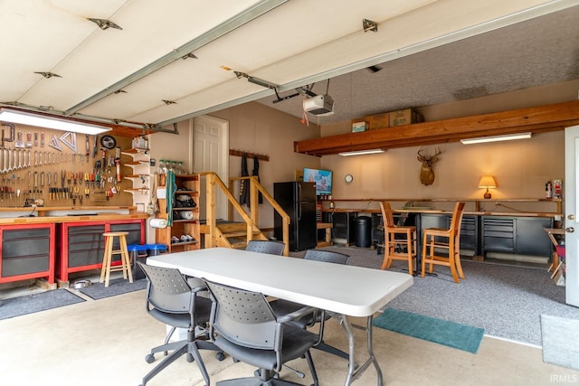 534 Lagrange St, West Lafayette, IN 47906 - garage with a workshop area, a garage door opener, and freestanding refrigerator