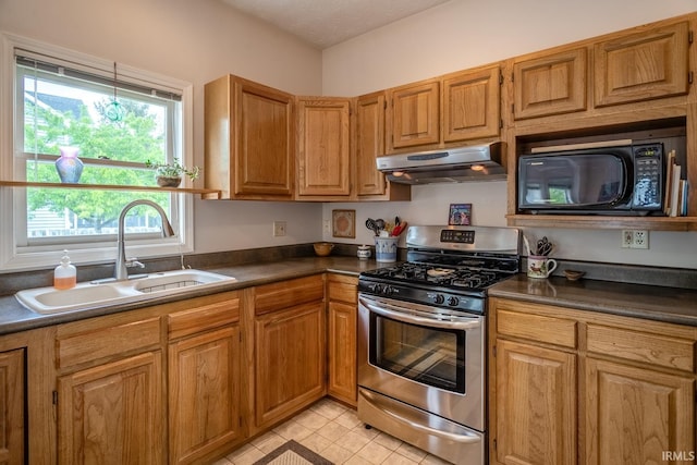 534 Lagrange St, West Lafayette, IN 47906 - kitchen with dark countertops, black microwave, a sink, stainless steel range with gas stovetop, and under cabinet range hood