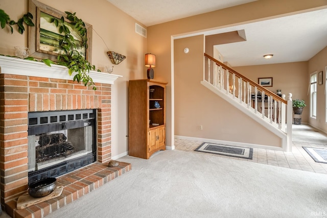 534 Lagrange St, West Lafayette, IN 47906 - living room with visible vents, a fireplace, stairway, baseboards, and carpet