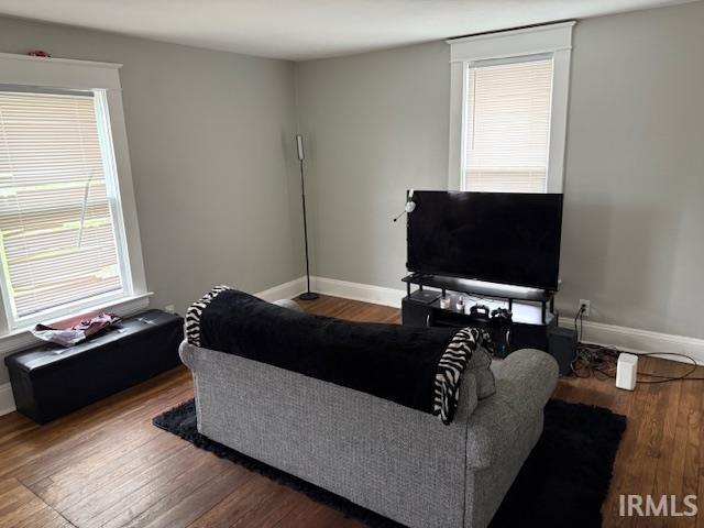 living room featuring baseboards and wood finished floors