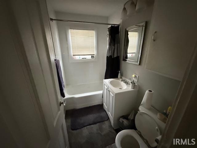 bathroom featuring vanity, shower / bath combo, and toilet