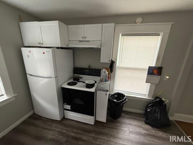 kitchen with freestanding refrigerator, under cabinet range hood, range with electric cooktop, and dark wood-type flooring
