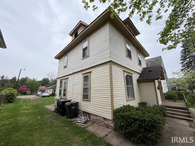 view of property exterior with a yard