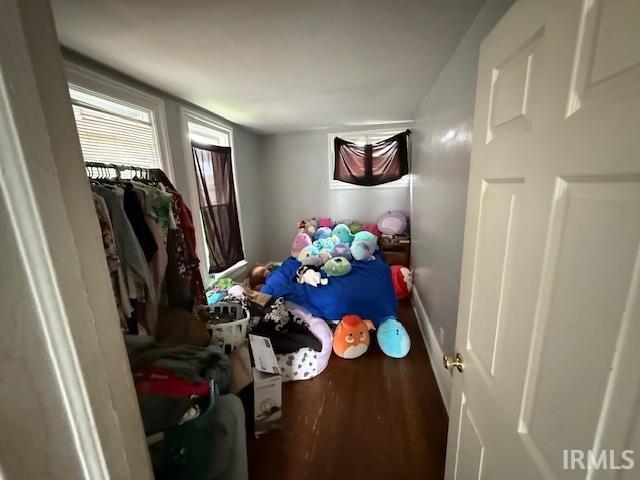 bedroom with baseboards and wood finished floors