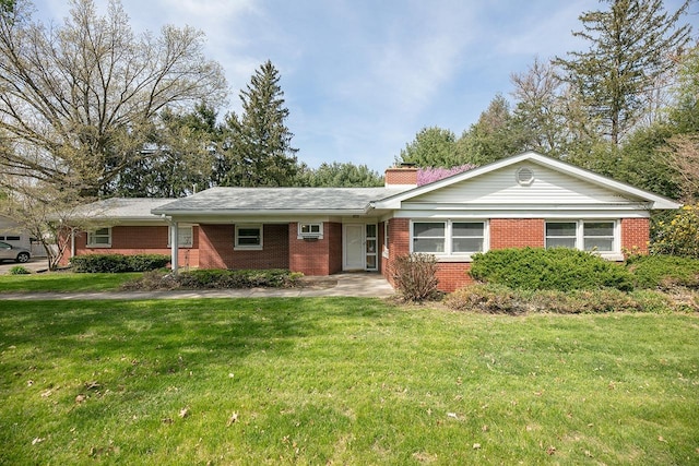 ranch-style house with brick siding, a front lawn, and a chimney